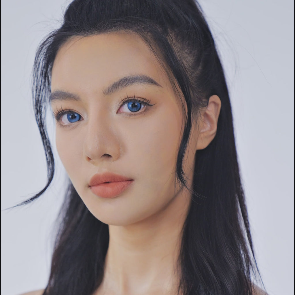 Model showcasing EyeCandys Bunnie Jelly Blue colored prescription lens in a detailed eye close-up video.