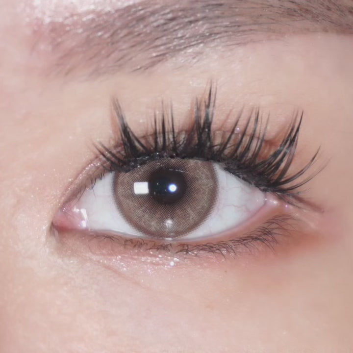 Close-up video of an eye with long lashes wearing EyeCandys Doe Golden Brown prescription colored contact lens, showcasing warm golden brown tones.