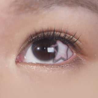 Long-lashed eye wearing EyeCandys Pink Star contact lens – delicate pink stars add depth and sparkle for a playful, dreamy effect.