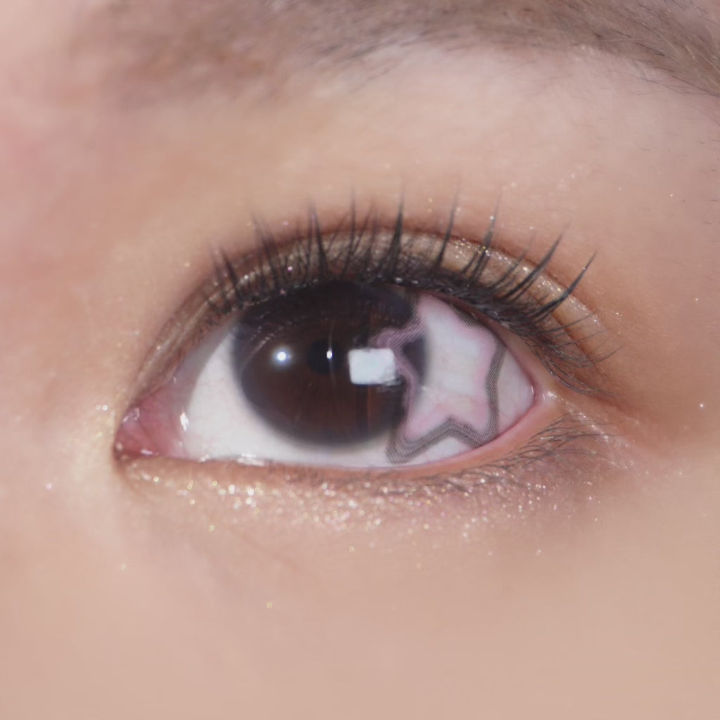 Long-lashed eye wearing EyeCandys Pink Star contact lens – delicate pink stars add depth and sparkle for a playful, dreamy effect.