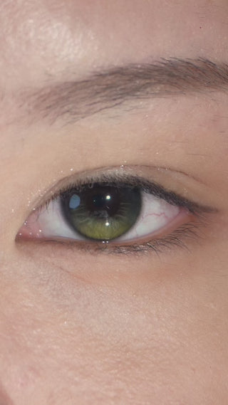 Close-up of a human eye wearing EyeCandys prescription colored contact lenses and glue-free false lashes, showcasing enhanced eye color and fuller, defined eyelashes.