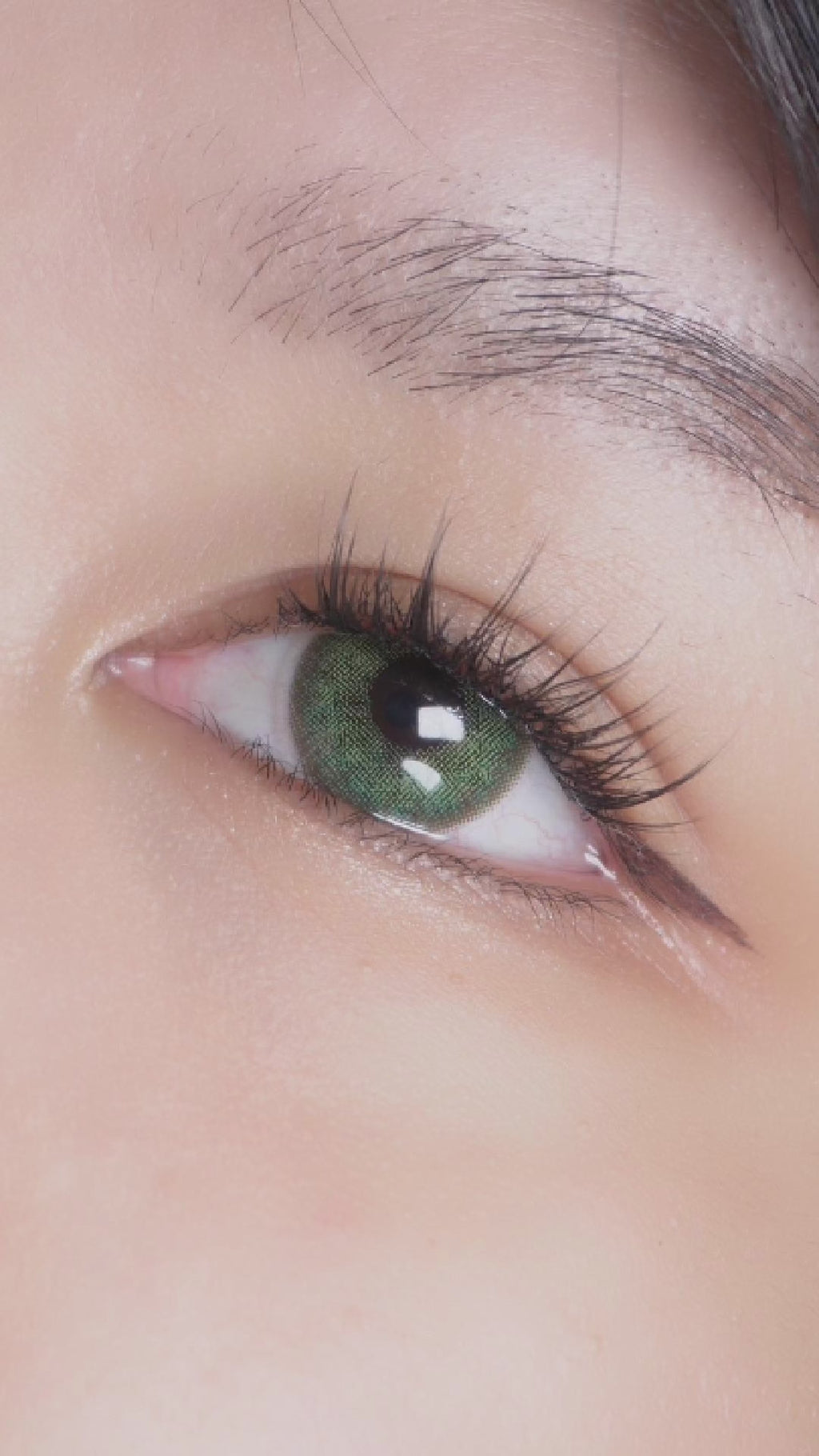 A video of a dark brown eye before and after wearing Isla Emerald Green colored prescription contact lens by EyeCandys