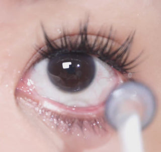 Close-up of an eye wearing EyeCandys Doe Blue contact lenses, featuring a natural deep blue color with subtle pattern for a soft, doe-eyed look.