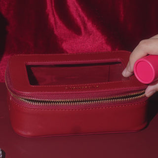 EyeCandys Red Holiday Essentials Case with clear window, structured shape, and gold snowflake hardware, perfect for lenses, drops, gel nail stickers, and travel staples.