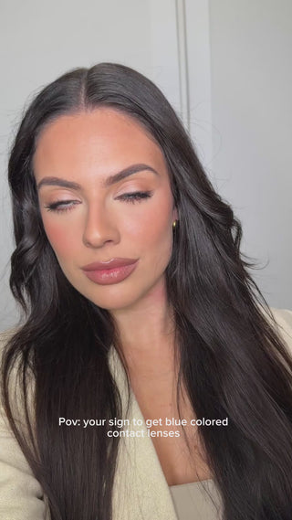 Model with natural makeup showcasing EyeCandys Desire Glacier Blue prescription colored contact lenses
