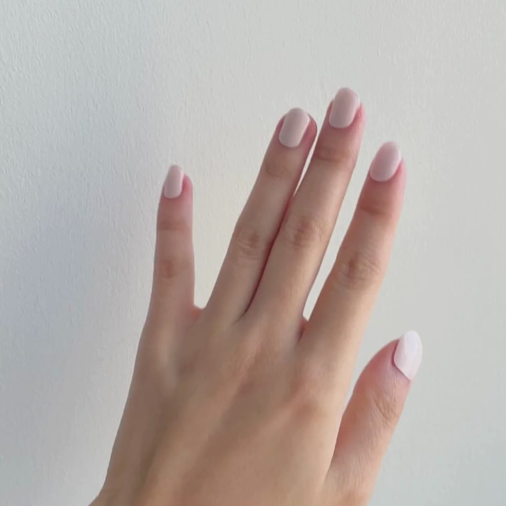 Model's hand showcasing EyeCandys Nudist Gel Nail Stickers. These nude-colored stickers offer a natural, elegant look with a long-lasting, chip-free finish, perfect for effortless and stylish manicures