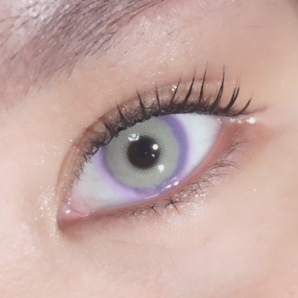 Dark brown eye wearing Eyecandys Pink Label Mykonos Violet prescription colored contact lens, natural violet eyes look