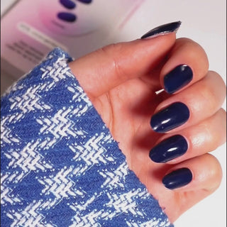 Model's hand showcasing EyeCandys Midnight Magic Gel Nail Stickers. These dark, shimmering stickers offer a bold, elegant look with a long-lasting, chip-free finish, perfect for a stylish and sophisticated manicure