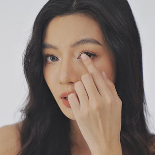 Model wearing EyeCandys Bunnie Milky Ash Grey colored contact lenses, showcasing soft ash grey eyes with a milky finish, realistic iris details, and a natural elegant eye look.