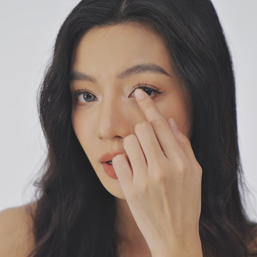Model wearing EyeCandys Bunnie Milky Ash Grey colored contact lenses, showcasing soft ash grey eyes with a milky finish, realistic iris details, and a natural elegant eye look.