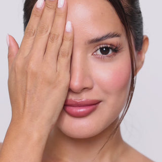 Female model with long lashes wearing EyeCandys Cashmere Satin Olive green contact lenses, showcasing soft olive-colored eyes, natural-looking enhancement, and a stylish everyday appearance.
