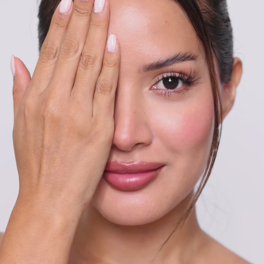 Female model with long lashes wearing EyeCandys Cashmere Satin Olive green contact lenses, showcasing soft olive-colored eyes, natural-looking enhancement, and a stylish everyday appearance.