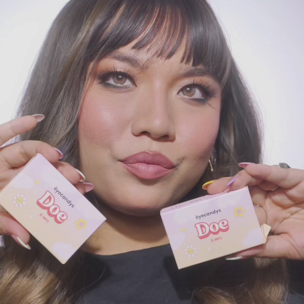 Video showing model wearing EyeCandys Doe Golden Brown colored contact lenses. Close-up of face and eyes highlighting warm honey-brown iris, long lashes, and natural limbal ring for a soft, wide-eyed effect.