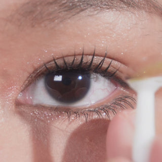Model try-on wearing EyeCandys Cashmere Satin Olive colored contact lenses with long lashes, displaying a realistic olive green eye effect, smooth blending, and enhanced eye beauty.