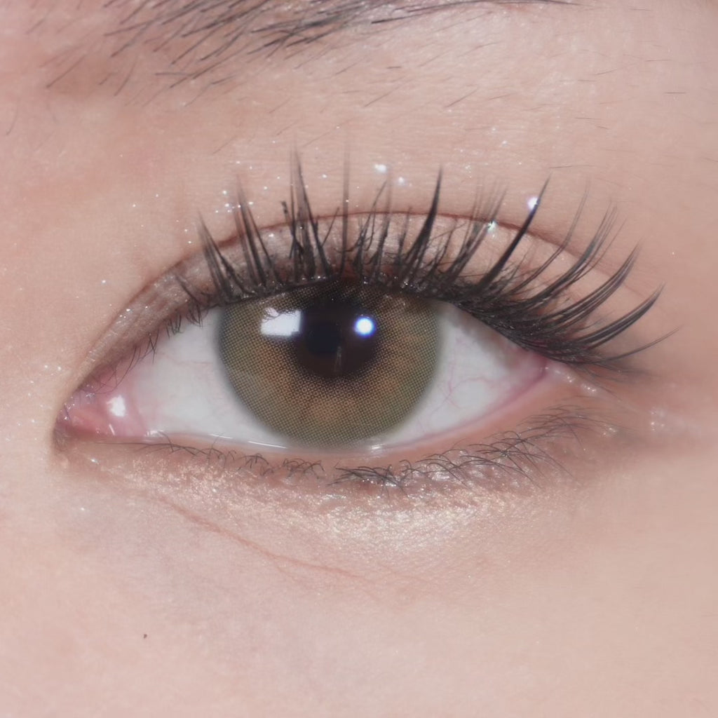 Close-up video of eye with long lashes wearing Eyecandys Cashmere Hazel prescription colored contact lens, showcasing natural hazel tone, lens detail, and comfortable fit.