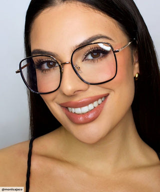 Model wearing Eyecandys Rini Oversized Square Glasses – Stylish oversized square eyeglasses in black and gold, designed for bold, confident looks, flattering on round and oval face shapes.