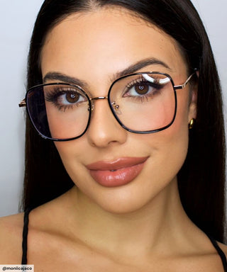 Model wearing Eyecandys Rini Oversized Square Glasses – Stylish oversized square eyeglasses in black and gold, designed for bold, confident looks, flattering on round and oval face shapes.