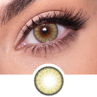 Close-up shot of a model eye wearing Desire Sandy Beige colored contact lens in one eye that is naturally dark-brown with natural rosegold eye make up