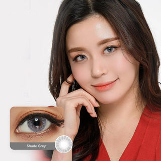 Smiling model wearing grey contact lenses on top of her dark eyes juxtaposed with a composite of an eye wearing the same Shade Grey lens and the design of the lens itself.