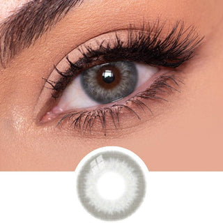 Close-up view of EyeCandys Sugarlook grey contact lens on a model's dark eye, paired with natural eye makeup, above the graphic design of the grey eye contacts.