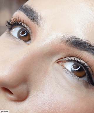 Model wearing Sunlit Hazel coloured contact lenses, showing the slight enlarging and defining effect on naturally dark eyes.