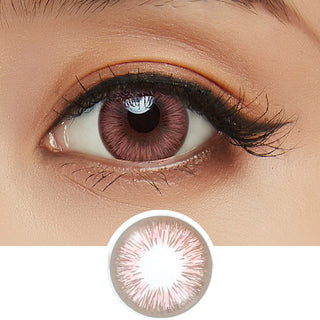 Close-up shot of model's eye adorned with Acuvue 1-Day New Define Fresh Rose pink color contact lens dailies, complemented by clean eye makeup, showing the brightening effect of the pink contact lens on dark brown eyes, above a cutout of the colour contact lens design with radial spiked pattern.