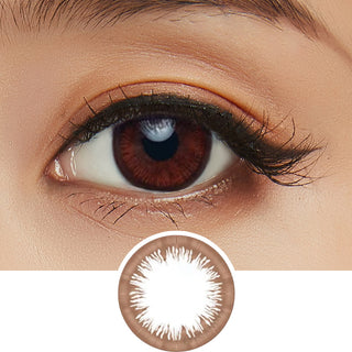 Close-up shot of model's eye adorned with Acuvue 1-Day Vivid Choco Brown color contact lens dailies, complemented by clean eye makeup, showing the brightening effect of the circle lenses on dark brown eyes, above a cutout of the colour contact lens design with radial spiked pattern