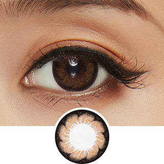 Design of the Pink Label Blossom Brown Colored Contacts Circle Lenses from Eyecandys on a white background, showing the pixel detail. While a separate illustration, above, a detailed photograph focuses on the eyes of a model, showcasing the Pink Label Blossom Brown contact lens prominently. This is accompanied by natural glowing eyeshadow and mascara. 
