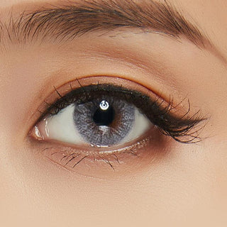 Shade Grey contact lens overlaid on a brown iris, paired with natural eye make up