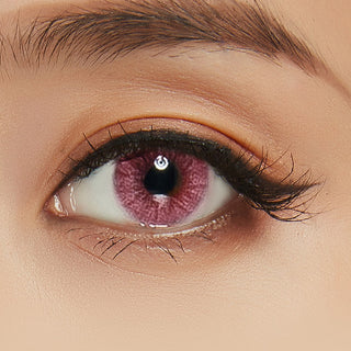 Macro shot of Shade Pink contacts with intricate spiral dot design, worn on a dark brown Asian eye