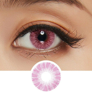 Close-up view of an opaque Shade Pink contact lens on a dark brown eye, paired with natural eye makeup, next to a cutout of the contact lens
