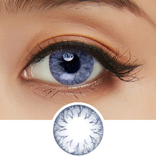 Detailed view of Pink Label Soony Blue contact lens against a white backdrop complemented by peach eyeshadow, with a cut-out of the same lens below