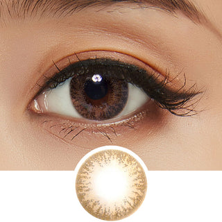 Detailed view of a Pink Label Moonlight Brown natural contact lens on a dark brown eye, showing the eye-enlarging effect of the circle lens, above a detailed design of the lens itself.