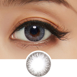 Detailed view of a Pink Label Moonlight Grey contact lens on a dark brown eye, showing the eye-enlarging effect of the circle lens, above a detailed design of the lens itself.