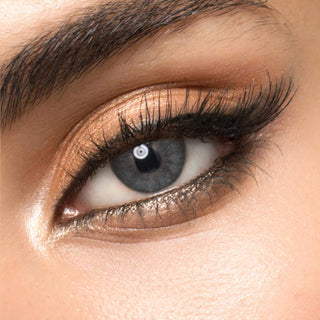 Close-up of Melbourne Grey circle lenses on a model's eye, showing the realistic subtle enlarging effect.
