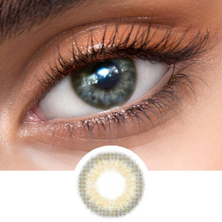 Close-up view of EyeCandys Sugarlook brown contact lens on a model's dark eye, paired with natural eye makeup, above the graphic design of the brown eye contacts.