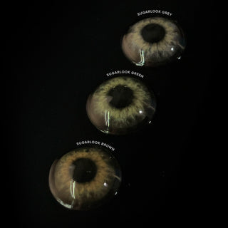 Macro shot of the EyeCandys Sugarlook Green, Brown and Grey contact lenses showing the graphic detail, on a black background