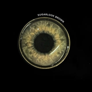Macro shot of the EyeCandys Sugarlook Brown contact lenses showing the graphic detail, on a black background