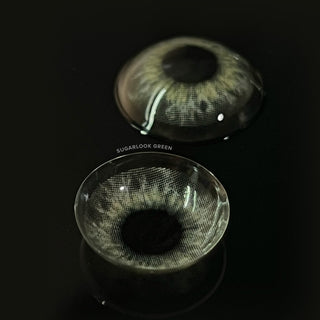 Macro shot of the EyeCandys Sugarlook Green contact lenses showing the graphic detail, on a black background
