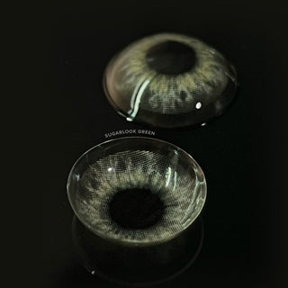 Detailed image of EyeCandys Sugarlook green contact lens with a contrasting dark backdrop