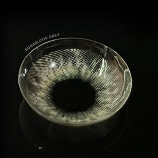 Macro shot of the EyeCandys Sugarlook Grey contact lenses showing the graphic detail, on a black background