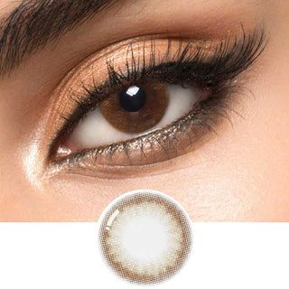 A brown circle contact lens on top of a brown eye with smoky eye makeup and long eyelashes, above the design of the contact lens itself.