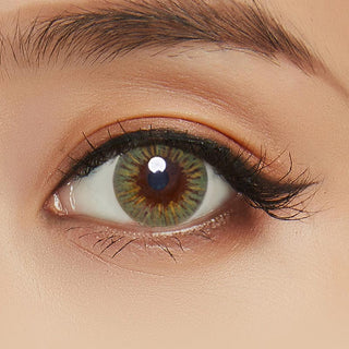 Close-up shot showcasing the model's eye adorned with Birthday green contact lens complemented by peach eyeshadow