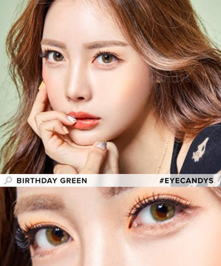 Asian model is presenting Birthday Green contact lenses, with her chin resting on her hands and index finger touching her red lips, emphasizing the enhanced eyes from the green contacts in a close-up photograph