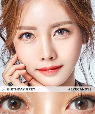 Asian model showcases Birthday Grey contact lenses, gently touching her cheeks, highlighting the captivating effect of the grey contacts in a close-up image.