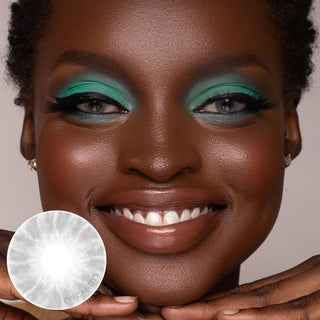 Dark-skinned model wearing the Shade Grey contact lens on her naturally black eyes, paired with bright turquoise eyeshadow, next to a cutout of the contact lens design.