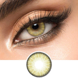 Close-up view of EyeCandys Desire Sandy Beige contact lens over a brown iris, demonstrating color transformation paired with natural eye makeup, next to a cutout of the contact lens