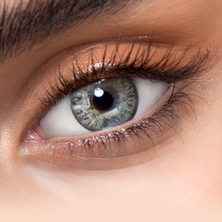 Close-up shot of model's eye adorned with Eyelighter Grey colored contacts for astigmatism, complemented by clean eye makeup