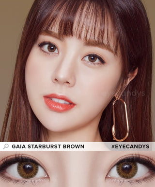 The model presents the Pink Label Starburst Brown contact lenses, complemented by a hint of red lipstick, resulting in a unique appearance. The photo features a close-up of the eyes embellished with the Brown contacts, highlighting their transformative impact.