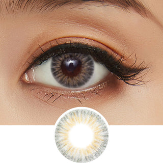 Wearing Pink Label Starburst Grey contact lenses, featuring a grey starburst design, complemented by peach eyeshadow. Additionally, there's a separate image showcasing a cut-out of the same lens.